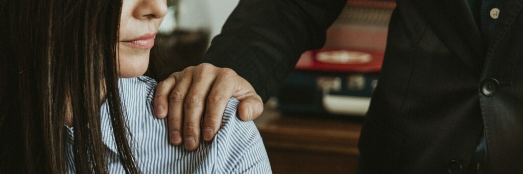 Businessman patting a colleague on her shoulder